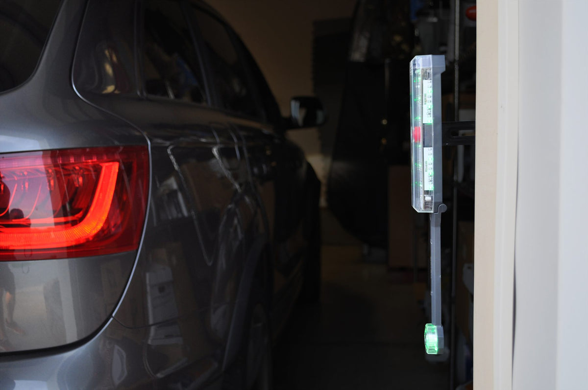 Vehicle approaching the illuminated side parking sensor in a garage